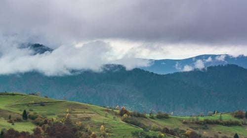 Landscapes of Green Hills Under a Layer of White and Fluffy Clouds