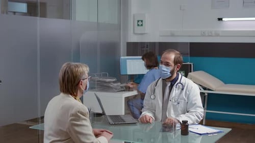Doctor Consults with Senior Woman in Medical Office