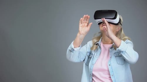 Senior Woman Using Virtual Reality Headset with Hand Gestures