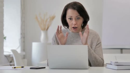 Woman Shocked and Upset Using Laptop