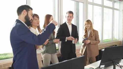 Professionals Chatting During Coffee Break in Bright Office