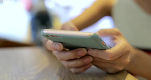 Woman typing on mobile phone at outdoor