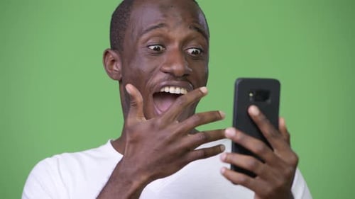 Man Reacts with Shock at Something on Phone