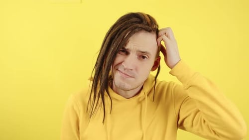 Young Man with Dreadlocks Looking Confused