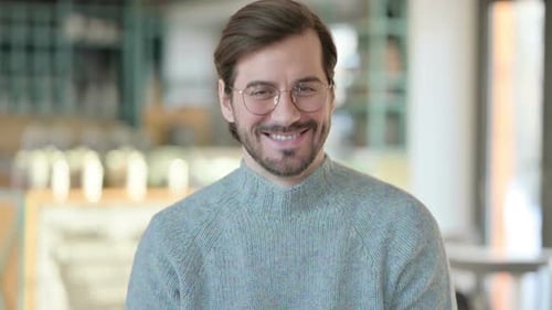 Smiling Man in Glasses and Sweater