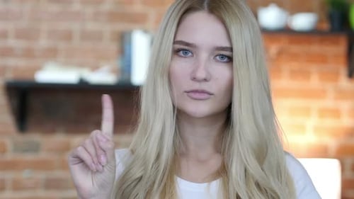 No, Not allowing Gesture by Waving Finger by Young Girl