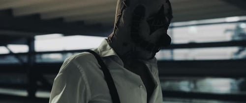 Masked Figure with Suspenders in Dark Urban Setting