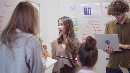 Adults Collaborating in Modern Workplace Discussing Strategy