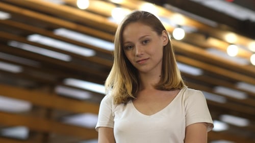 Cute fashionable young woman smiling to camera.