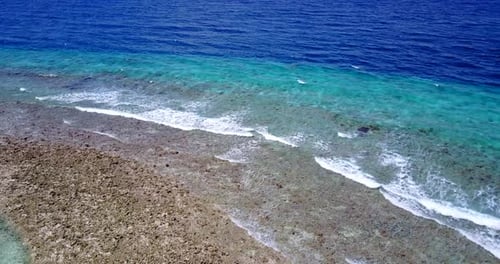 Tropical above abstract shot of a sunshine white sandy paradise beach and aqua turquoise water backg