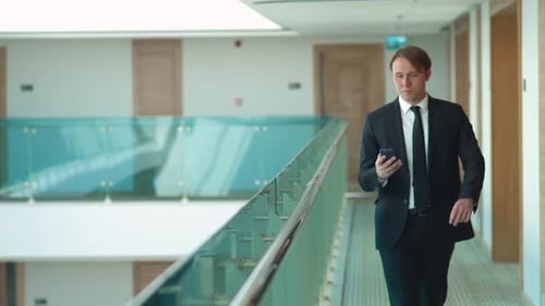 Man in Suit Talking on Phone in Modern Office