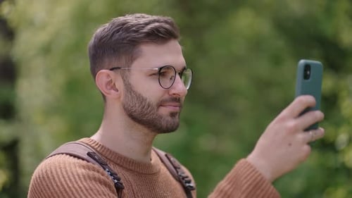 Young Adult Man Using Phone Outdoors