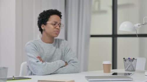 Stressed Young Woman at Desk in Office