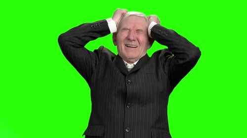 Senior Man Holding Head in Distress on Green Screen