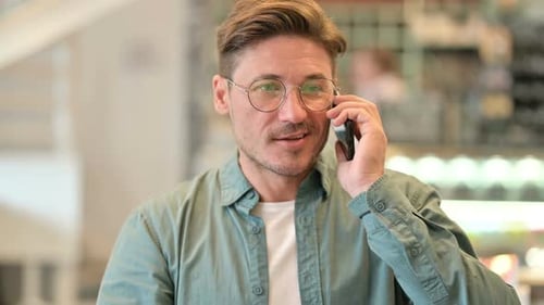 Man Talking on Smartphone Indoors