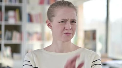 Woman Shakes Head and Crosses Arms in Refusal