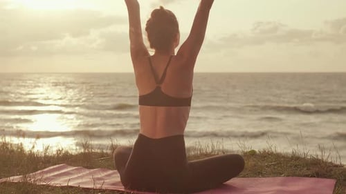 Young Girl Doing Yoga By the Sea
