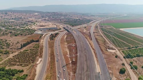 Aerial footage of large highway construction project with tunnels and bridges