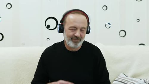 Senior Man Listening to Music on Headphones