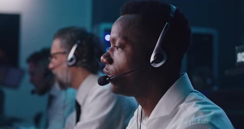 Operators Work in Modern Control Room with Headsets
