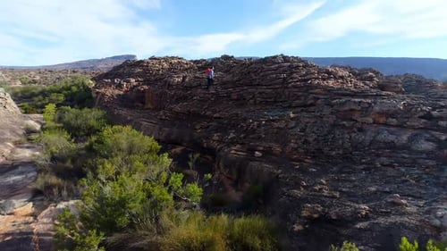 Male rock climber walking over a rocky mountain 4k
