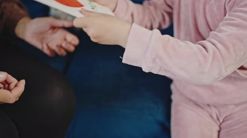 Child Gives Parent Handmade Birthday Card at Home