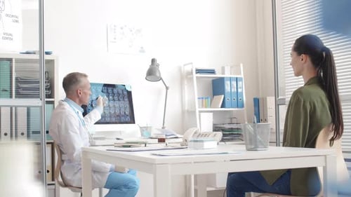 Doctor Explains Brain Scan to Patient in Office