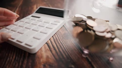 A Woman is Calculating Her Expenses for a Month