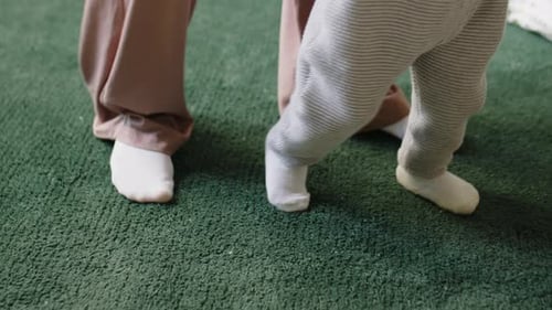 Infant Learns to Walk with Adult at Home