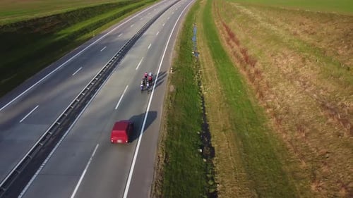 Cyclists Ride Down Highway, Aerial View