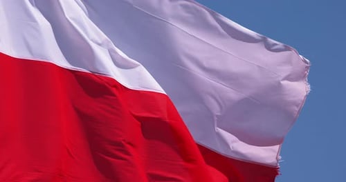 Flag Waving in the Wind Against Blue Sky