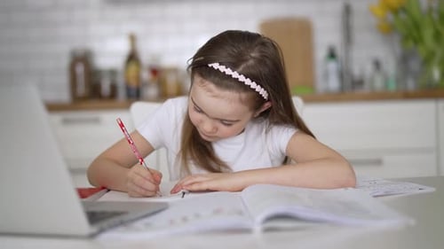 Girl Doing Homework at Kitchen Table