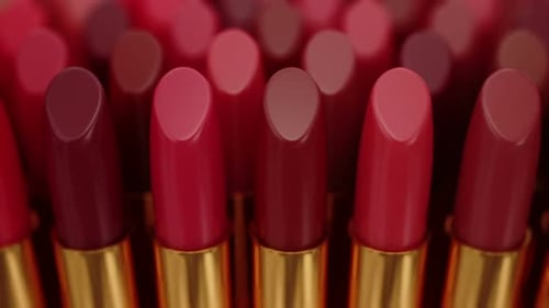 Dynamic Close-Up of Various Shades of Lipsticks