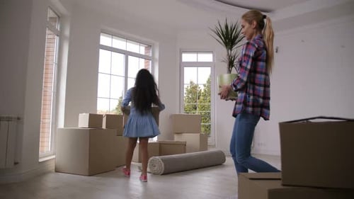 Happy Family Carrying Boxes Moving in New House