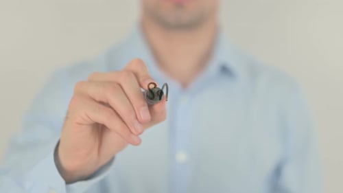 Man Writes Sales Strategy on Clear Surface