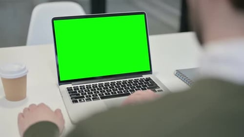 Young Businessman Using Laptop with Green Screen