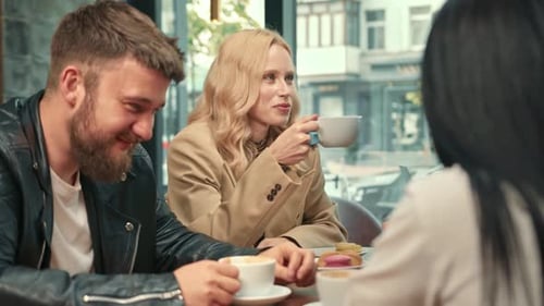 Friends Talking and Laughing at a Cafe
