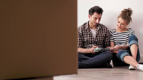 Young Couple Discuss Paint Colors in New Home