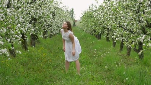Girl dancing in the orchard