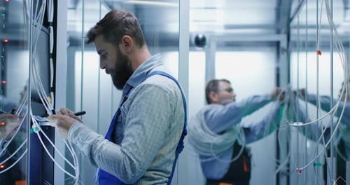 Two Technicians Working in a Data Center