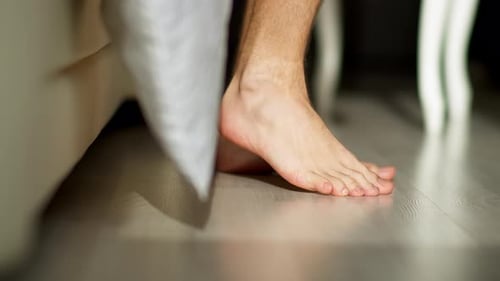 Man Gets out of Bed in the Morning