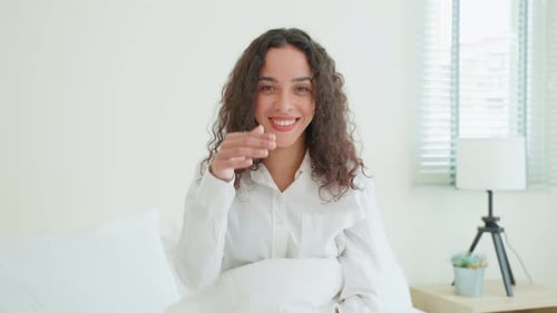 Happy Woman Smiling at Camera in Bedroom