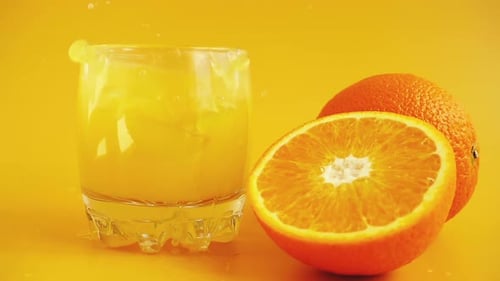 Fresh Orange Juice Splashing into a Glass