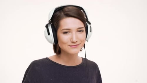 Woman with Headphones Listening to Music and Dancing