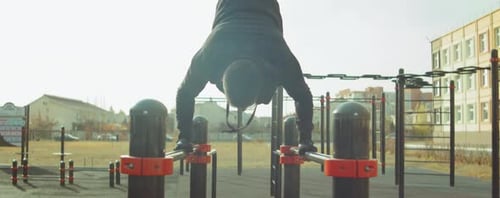 Man Doing Pull-Ups at an Outdoor Gym