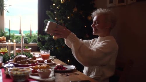 Family Celebrates Christmas Together at Dinner Table
