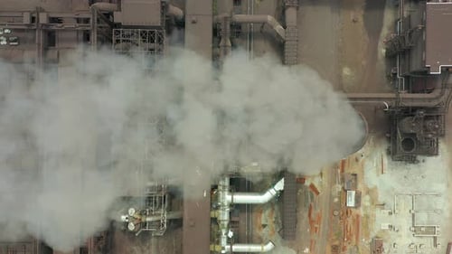 Aerial View of Industrial Complex with Smoke