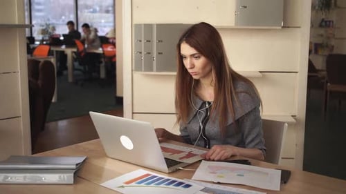 Woman Works on Computer in Bright Modern Office