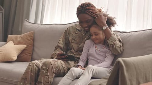 Woman with child on a sofa at home