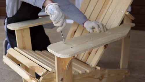Craftsman Assembling Wooden Chair with Screwdriver